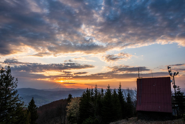 cottage on top of the mountain at sunrise in Beskydy Javorovy vrch, czech 13.4.2020 - Zdjęcie, obraz