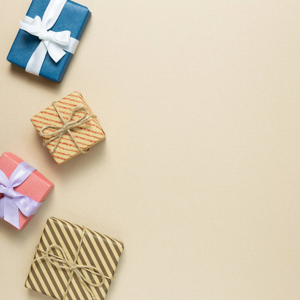 Gift boxes on beige background. flat lay, top view, copy space - 写真・画像