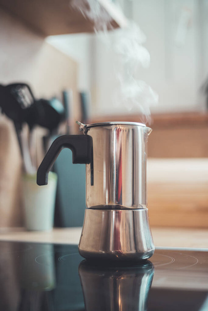Italian coffee cooker on hot stove, breakfast - Foto, imagen
