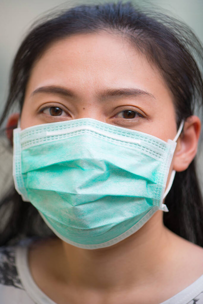 Asian Woman wearing protection face mask against coronavirus - Fotoğraf, Görsel