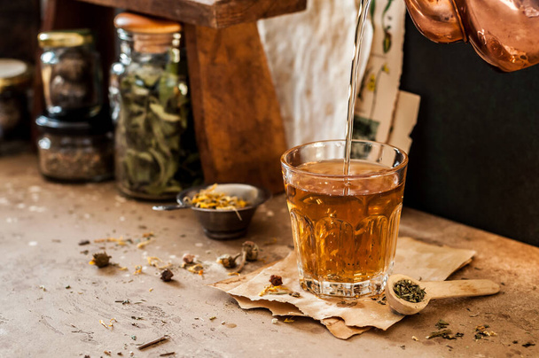 Pouring Herbal Tea into a Glass, Variety of Dried Herb Mixes, copy space for your text - Фото, зображення