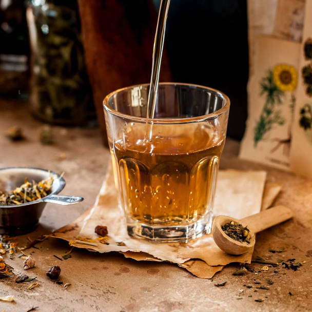 Pouring Herbal Tea into a Glass, Variety of Dried Herb Mixes, square - Fotoğraf, Görsel