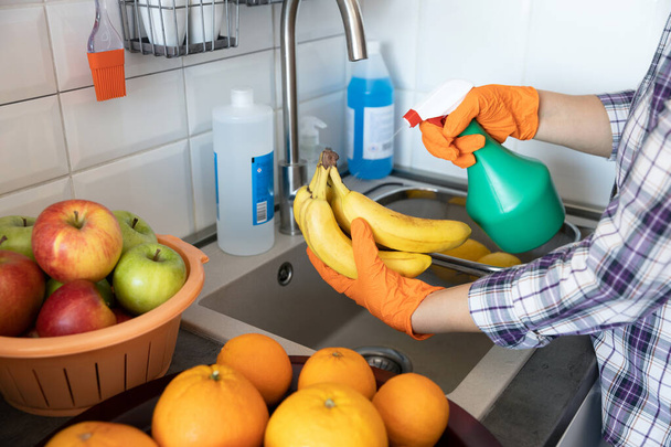 Spraying antibacterial chemical on the fruits in the kitchen - Foto, Imagem