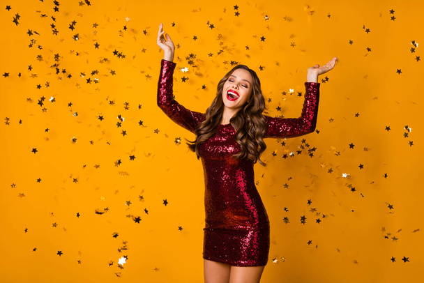 Photo of fancy crazy wavy lady red bright pomade festive event party dance night confetti falling catch glitter stars wear sequins burgundy mini dress isolated yellow color background - Fotoğraf, Görsel