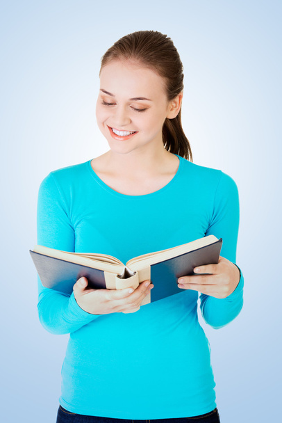 Young woman reading a book - Фото, зображення