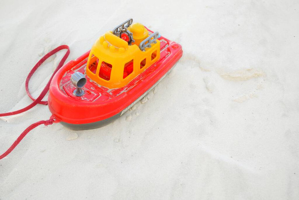Childrens toy boat on the white sand. - Photo, Image