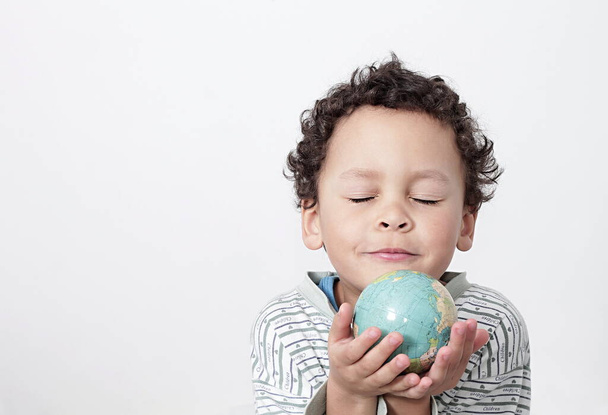 Image of a boy holding globe on earth day - Photo, Image