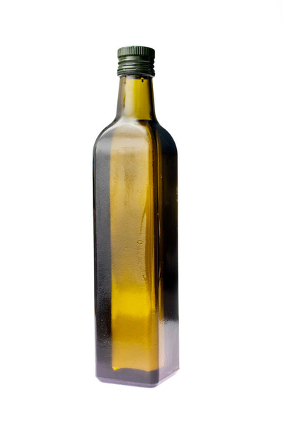 Dark glass bottle with refined olive oil isolated on white - Fotó, kép