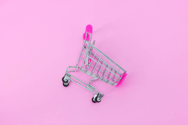 Small supermarket grocery push cart for shopping trendy modern fashion background. Sale buy mall market shop consumer concept. Copy space. Concept Online shopping - Photo, Image