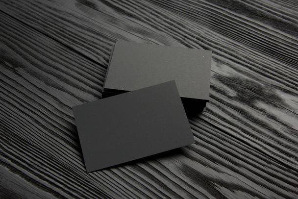 Business card blank on black wooden background. Corporate Stationery, Branding Mock-up. Creative designer desk. Flat lay. Copy space for text - Φωτογραφία, εικόνα