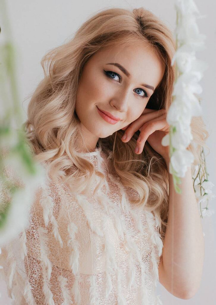 Portrait of beautiful blond woman with flowers - Foto, Imagem