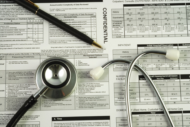 A stethoscope on the top of a medical utilization document - Photo, Image