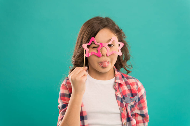 Feeling playful. showing tonue in glasses. small girl prefect casual fashion. happy kid in funny party glasses. school girl having fun. childhood happiness. child in playful and positive mood - Photo, image