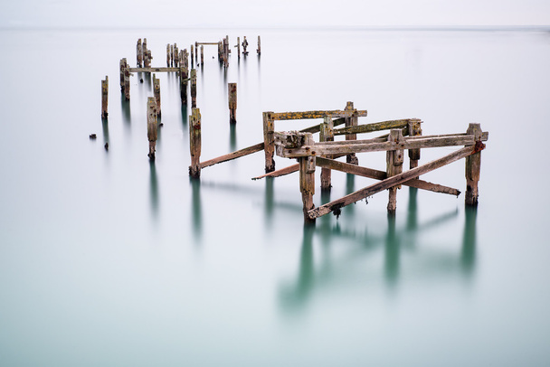 Fine art landscape image of derelict pier in milky long exposure - Photo, Image