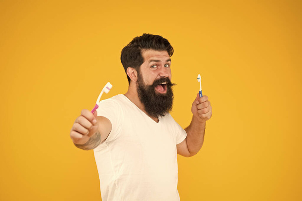Be always healthy. Bearded man hold toothbrushes. Dentistry and oral health. Healthy habits. Dental care. Tooth brushing. Healthy mouth. Keep teeth and gums healthy - Foto, Imagen