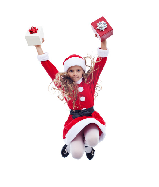 Little santa claus girl jumping high with presents - Фото, зображення