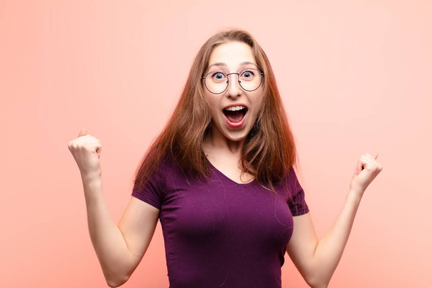 yound blonde woman looking extremely happy and surprised, celebrating success, shouting and jumping - Photo, Image