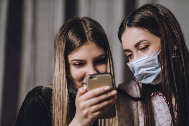 Two young females in medical protective masks. - Zdjęcie, obraz