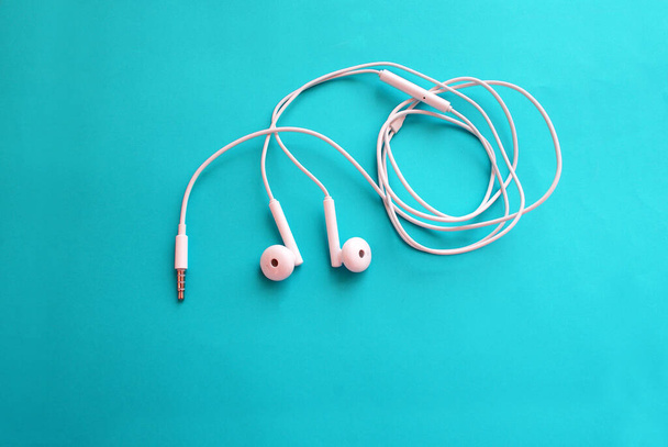 Headphones for a smartphone on a bright background, modern technology. - Valokuva, kuva