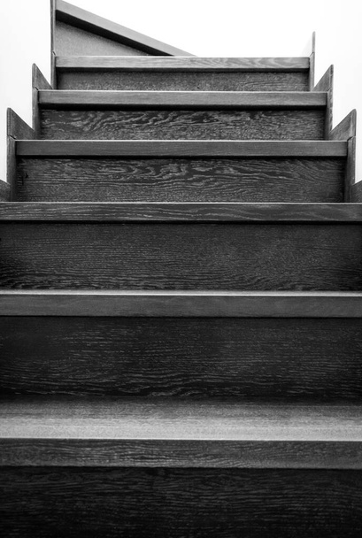 Wooden stairs in the house. Monochrome stairs up. Wooden interior elements. - Photo, Image