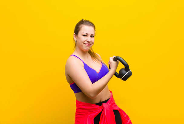 young blonde woman with a dumbbell. sport concept - Foto, Imagem