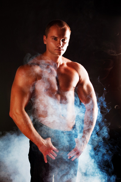 Young sporty man over Smoke. - 写真・画像