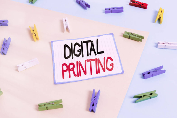 Conceptual hand writing showing Digital Printing. Business photo text digital based images directly to variety of media Colored clothespin paper reminder with yellow blue background. - Photo, Image