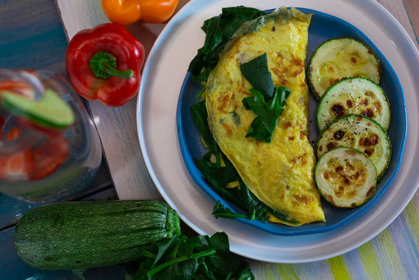 Tortilla with egg, spinach, zucchini and peppers for ketogenic diet. - Photo, Image