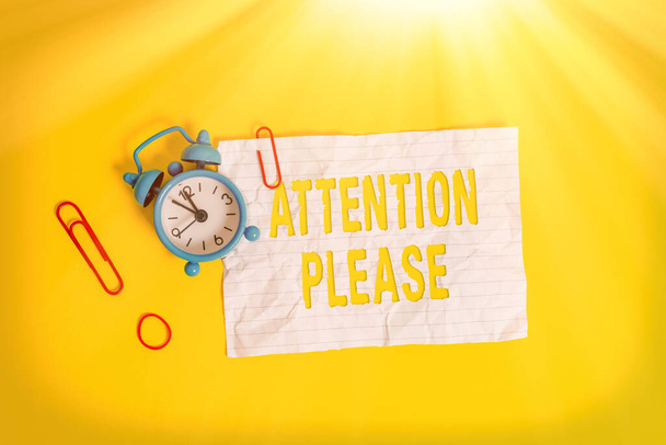 Writing note showing Attention Please. Business photo showcasing Asking showing to focus their mental powers on you Metal alarm clock blank crushed note rubber band colored background. - Photo, Image