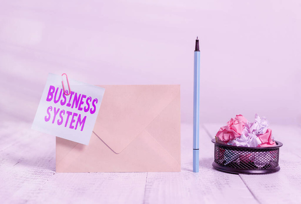Writing note showing Business System. Business photo showcasing A method of analyzing the information of organizations Envelope sticky note marker paper balls container wooden background. - Photo, Image
