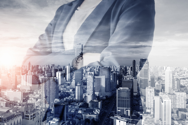 Business Real Estate and Commercial Building Service, Double Exposure Images of Business Woman Standing Arm Crossed With City Background. Business Property Buildings and Financial Estate Investment - Photo, Image