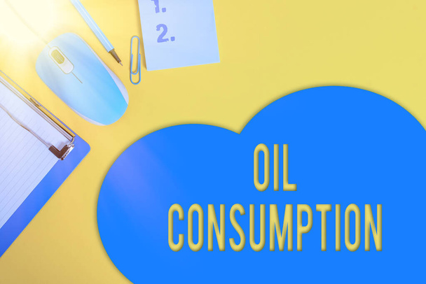 Word writing text Oil Consumption. Business concept for This entry is the total oil consumed in barrels per day Metal clipboard blank paper sheet clip mouse pencil note colored background. - Photo, Image