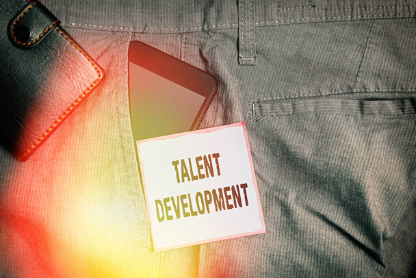 Word writing text Talent Development. Business concept for Building Skills Abilities Improving Potential Leader Smartphone device inside trousers front pocket with wallet and note paper. - Photo, Image