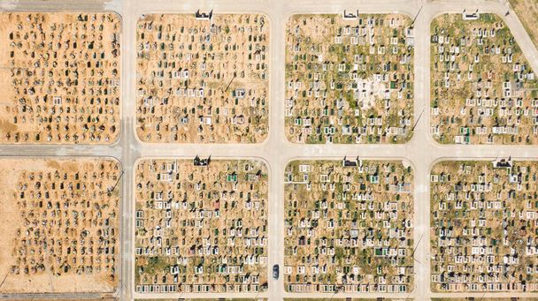 Aerial photo of cemetery graveyard showing the headstones and tombstones of the graves some are with flowers long shadows from the coming sundown. Ukraine, Europe - Photo, Image