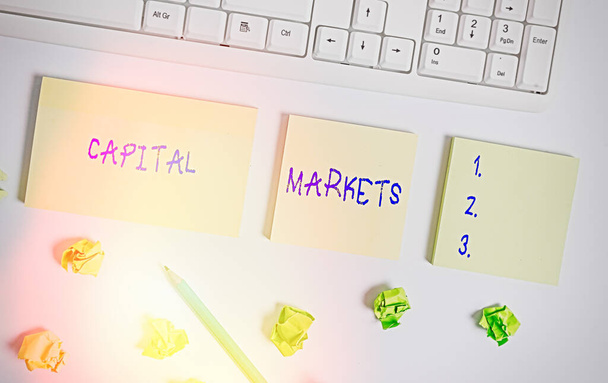 Writing note showing Capital Markets. Business photo showcasing Allow businesses to raise funds by providing market security Flat lay above blank copy space sticky notes with business concept. - Photo, Image