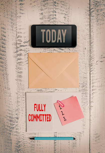 Word writing text Fully Committed. Business concept for Extremely agreed to do something in life definitely Envelop smartphone notepad note clip marker old wooden vintage background. - Photo, Image