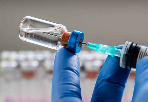close up on vaccine and medical syringe - Foto, afbeelding