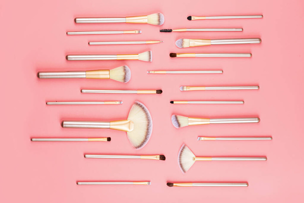 Cosmetic Makeup brushes on pink background. Flat lay, top view, copy space. Makeup accessories, mockup, template. - Zdjęcie, obraz
