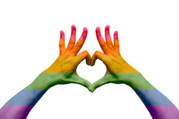 Persona mano en forma de amor con el color del arco iris aislado sobre fondo blanco. Día del orgullo y concepto de cero discriminación
. - Foto, imagen