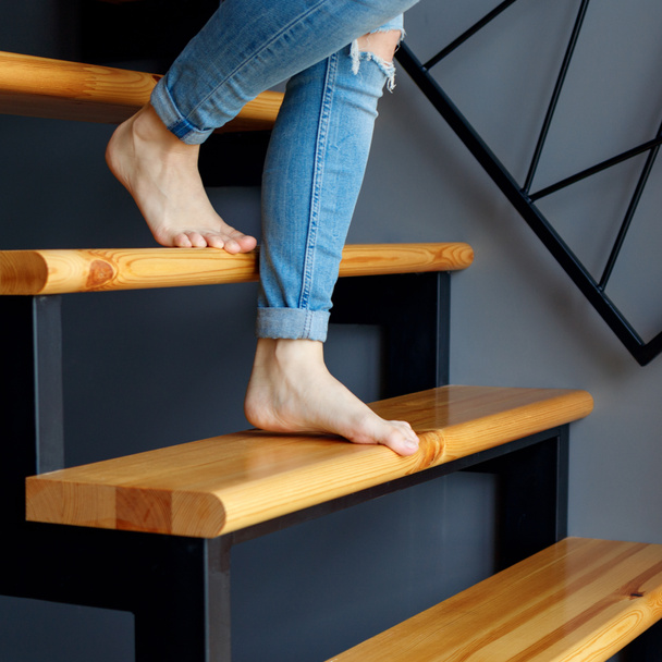Woman in blue jeans go down in stairs. - Photo, Image