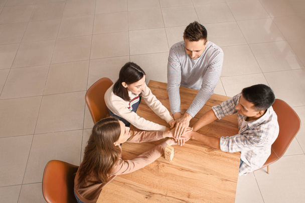 Team of business people putting hands together in office, top view - Photo, Image