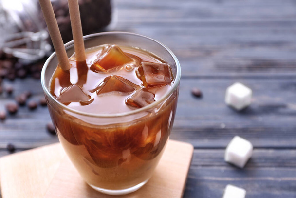 Glass of tasty iced coffee on table - Foto, imagen