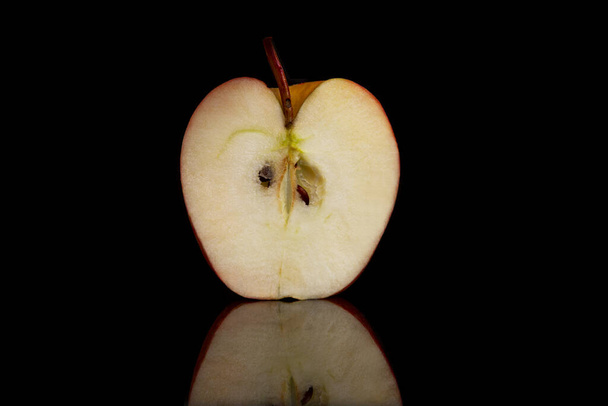 Een halve sappige appel op een zwarte achtergrond met reflectie. Een close-up. Gezonde levensstijl en vegetarisme. - Foto, afbeelding