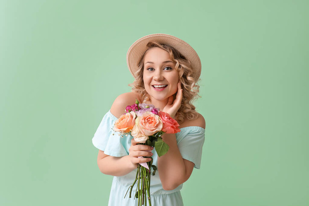 Beautiful young woman with bouquet of flowers on color background - Foto, imagen