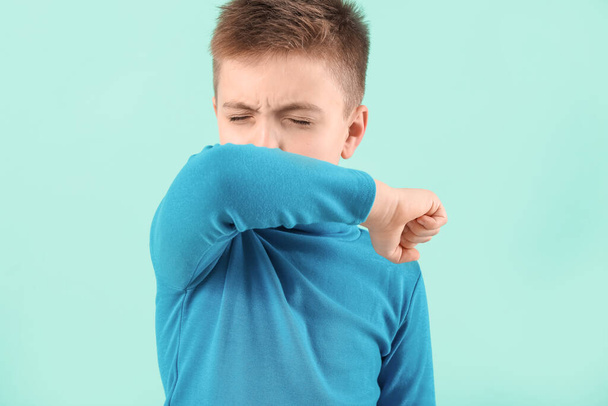 Ill coughing little boy on color background - Photo, image