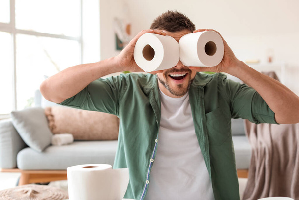 Happy man with toilet paper at home. Concept of coronavirus epidemic - Fotoğraf, Görsel