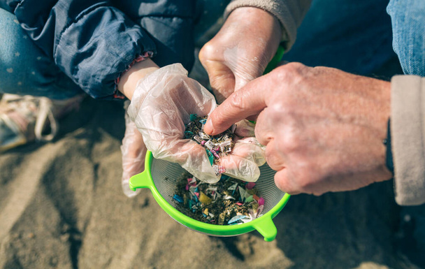 Colander with microplastics on the beach - Photo, Image