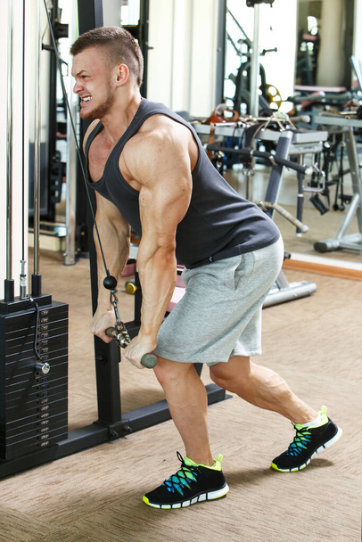 Fitness, bodybuilding. Powerful man during workout - Fotó, kép