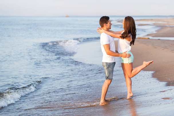Summer, sea. Cute, lovely couple on the beach - Foto, afbeelding
