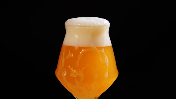 Light beer is pouring into glass. Foam dripping from the glass. Cold beer in a glass with water drops - Footage, Video